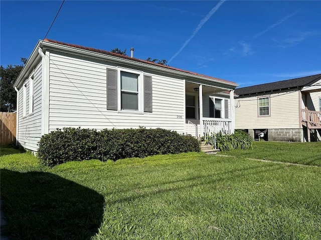 exterior space featuring a lawn and a porch