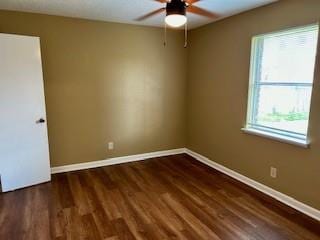 unfurnished room featuring ceiling fan and dark wood-type flooring