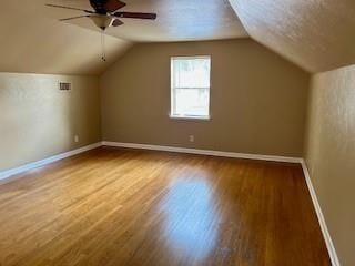 bonus room with hardwood / wood-style floors, ceiling fan, and lofted ceiling