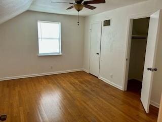 unfurnished bedroom with hardwood / wood-style floors, vaulted ceiling, and ceiling fan