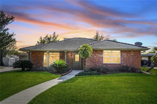 ranch-style home featuring a yard