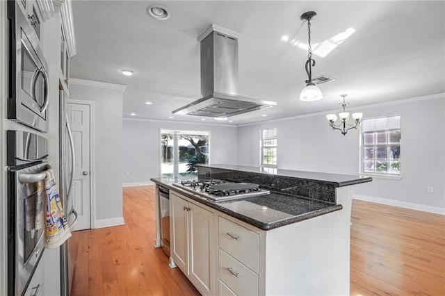 kitchen featuring island range hood, a kitchen island, light wood-type flooring, and stainless steel appliances