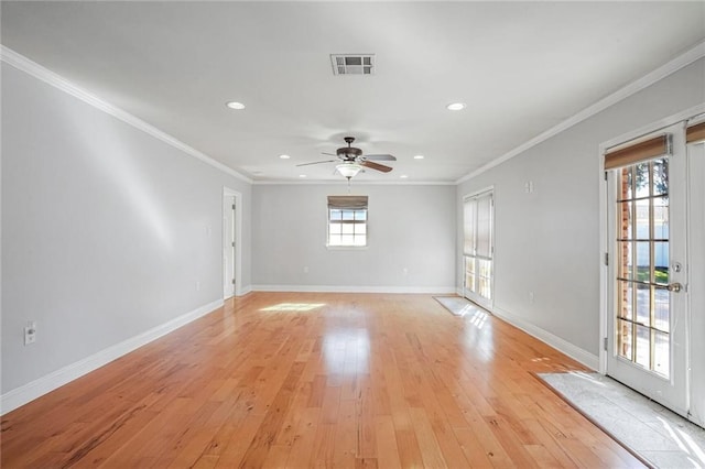 spare room featuring light hardwood / wood-style floors, plenty of natural light, crown molding, and ceiling fan