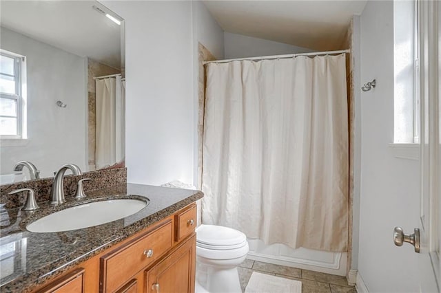 bathroom with tile patterned flooring, vanity, and toilet