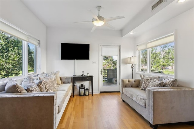 living room featuring ceiling fan, a healthy amount of sunlight, and light hardwood / wood-style floors