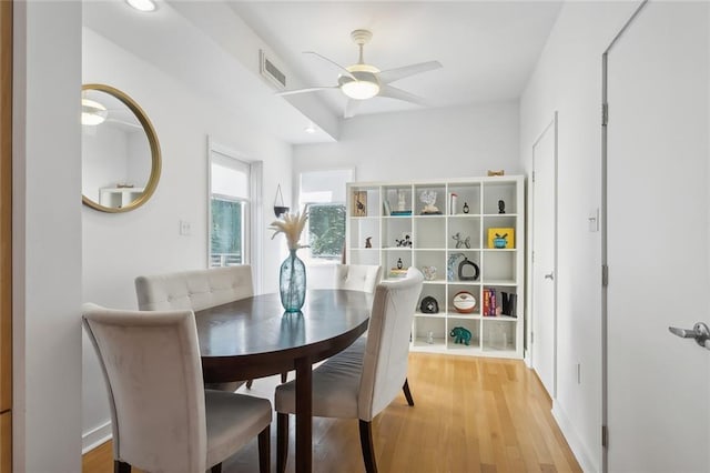 dining area with ceiling fan and wood-type flooring