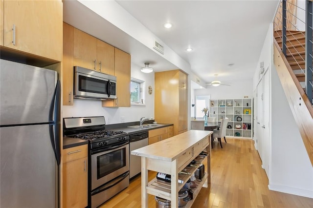 kitchen featuring ceiling fan, light hardwood / wood-style floors, sink, and appliances with stainless steel finishes