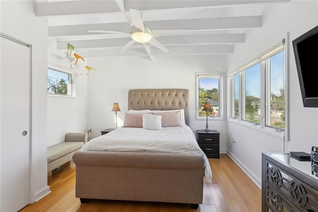 bedroom featuring multiple windows, ceiling fan, and light wood-type flooring