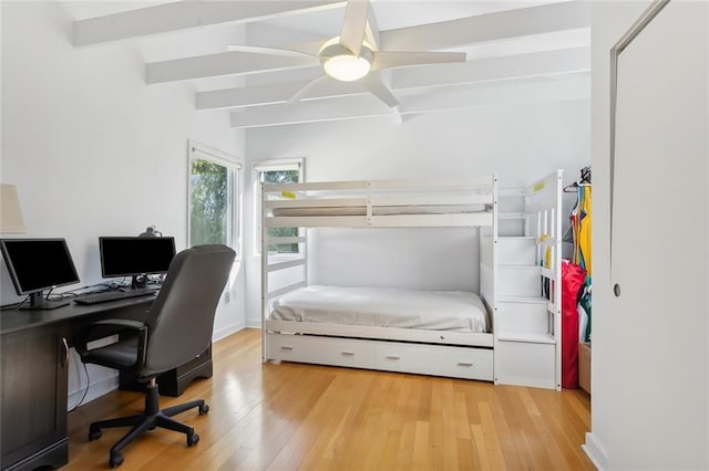 bedroom featuring beamed ceiling, ceiling fan, and light wood-type flooring