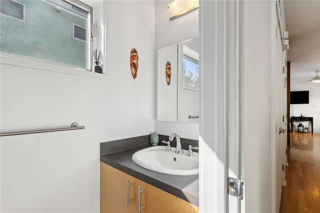 bathroom with hardwood / wood-style flooring, vanity, and ceiling fan