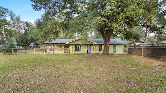 rear view of property with a yard