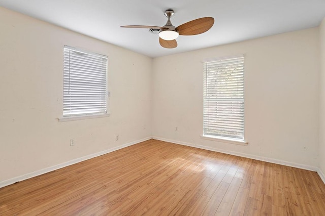 spare room with light wood-type flooring and ceiling fan