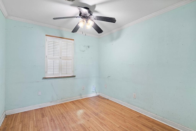 spare room with hardwood / wood-style flooring, ceiling fan, and crown molding