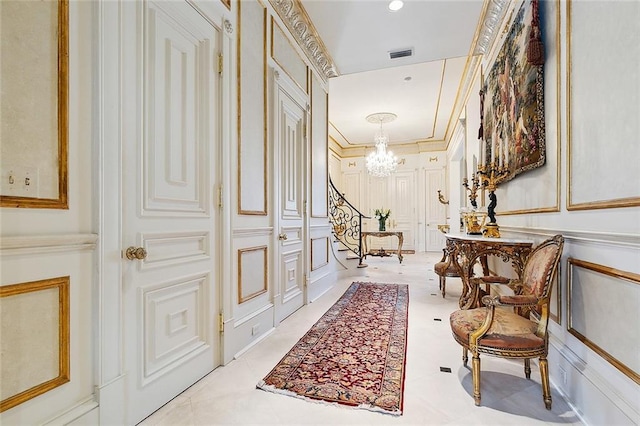 3832 Edenborn Ave, Metairie, LA 70002 - corridor featuring a decorative wall and a chandelier