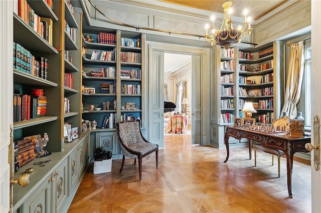 3832 Edenborn Ave, Metairie, LA 70002 - sitting room featuring a chandelier, bookshelves, crown molding, a desk, and built in shelves