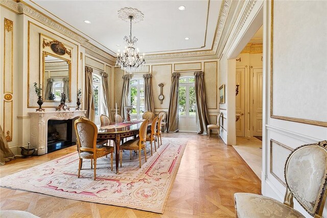 3832 Edenborn Ave, Metairie, LA 70002 - dining room featuring ornamental molding, a chandelier, a decorative wall, recessed lighting, and a high end fireplace