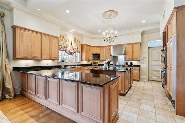 3832 Edenborn Ave, Metairie, LA 70002 - kitchen with appliances with stainless steel finishes, exhaust hood, a chandelier, a kitchen island, and crown molding
