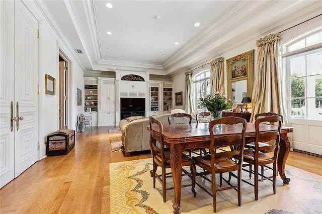 3832 Edenborn Ave, Metairie, LA 70002 - dining area featuring healthy amount of natural light, a tray ceiling, light wood-style floors, crown molding, and recessed lighting