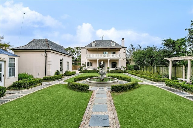 3832 Edenborn Ave, Metairie, LA 70002 - rear view of house with a balcony, a chimney, and stucco siding