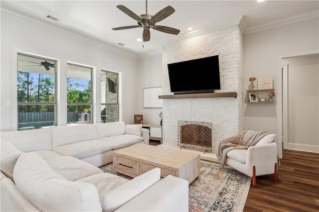 living room with a fireplace, dark hardwood / wood-style flooring, ceiling fan, and ornamental molding