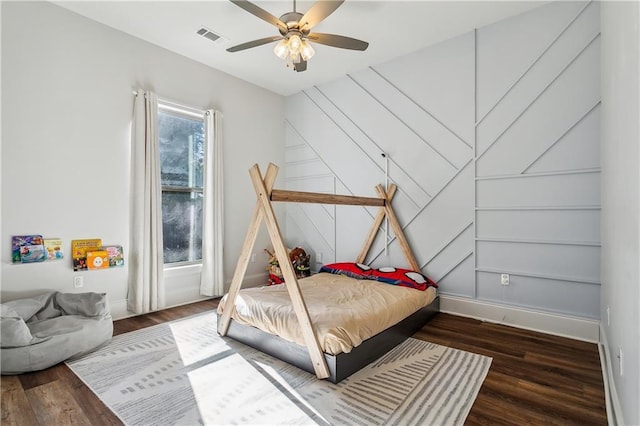 bedroom with ceiling fan and dark wood-type flooring