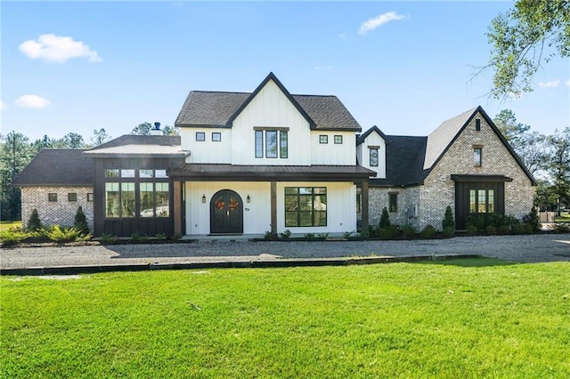 modern inspired farmhouse featuring a front lawn