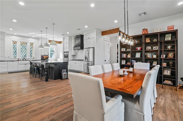 dining room featuring sink and light wood-type flooring