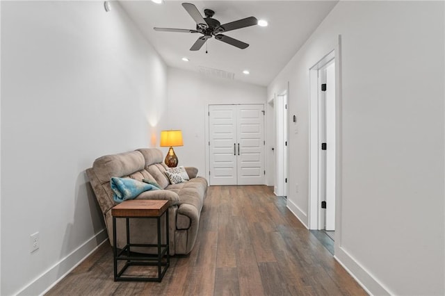 living area featuring vaulted ceiling, dark hardwood / wood-style floors, and ceiling fan