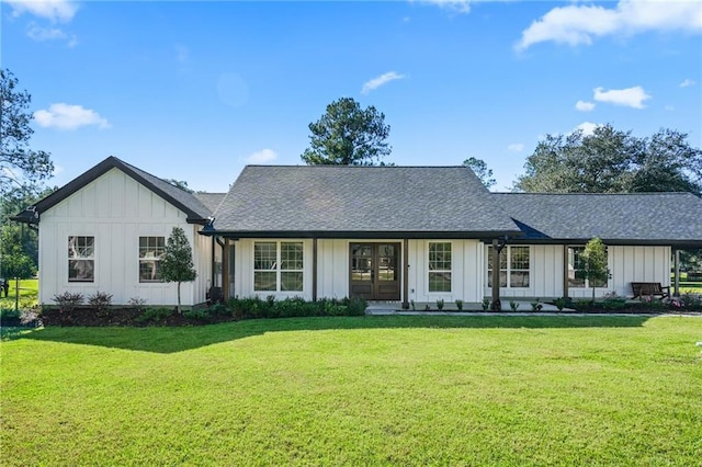 view of front of home with french doors and a front yard