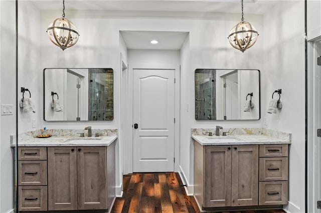 bathroom featuring hardwood / wood-style flooring, vanity, and an inviting chandelier