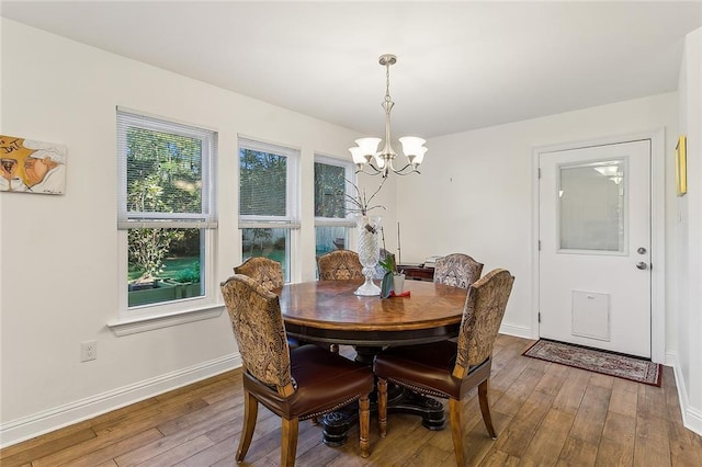 dining space featuring a chandelier and wood-type flooring