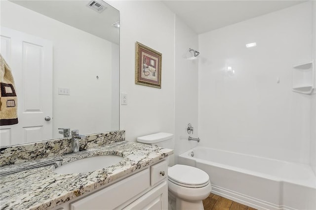 full bathroom with vanity, hardwood / wood-style flooring, toilet, and tub / shower combination