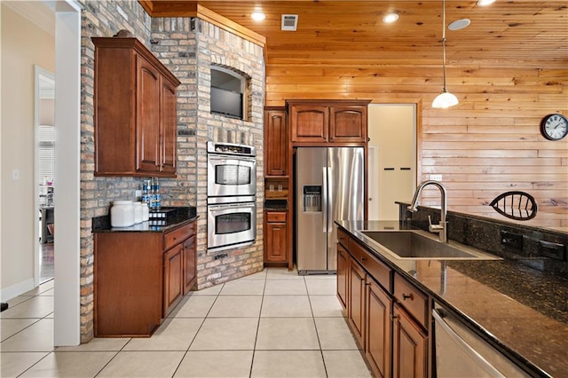 kitchen with sink, hanging light fixtures, light tile patterned flooring, wood ceiling, and stainless steel appliances