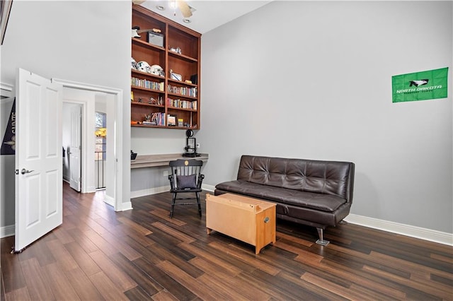 sitting room featuring dark hardwood / wood-style flooring and built in desk