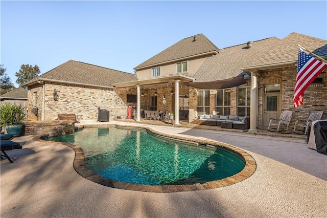 view of swimming pool with a patio area and an outdoor living space