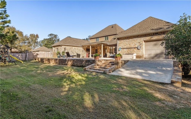 view of front facade featuring a playground, a patio area, a front yard, and a garage