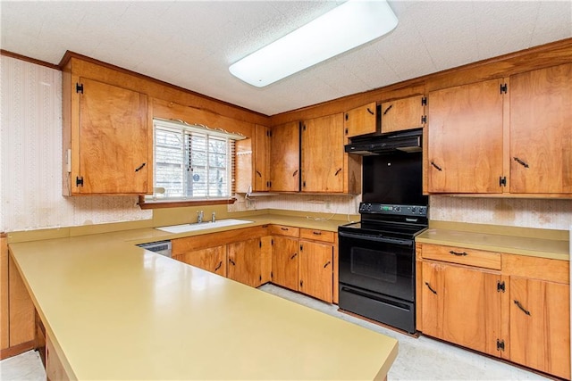 kitchen with electric range, under cabinet range hood, a sink, wallpapered walls, and light countertops