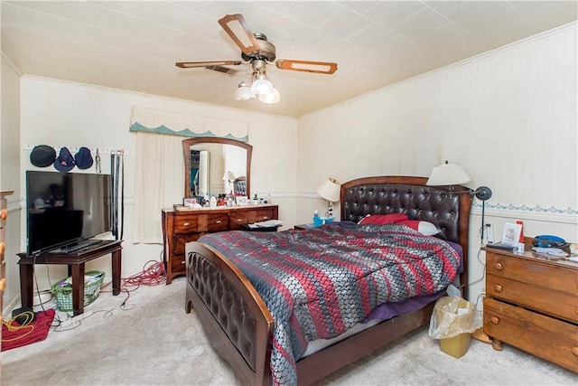 bedroom with ceiling fan, light colored carpet, and ornamental molding