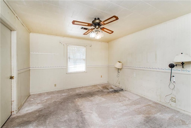 spare room with carpet flooring, visible vents, and ceiling fan