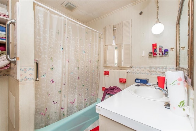 bathroom with shower / bath combo, ornamental molding, and vanity