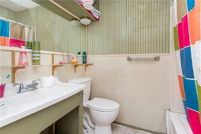 full bathroom with tile patterned flooring, vanity, shower / tub combo with curtain, and toilet