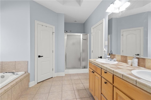 bathroom with tile patterned floors, separate shower and tub, and vanity