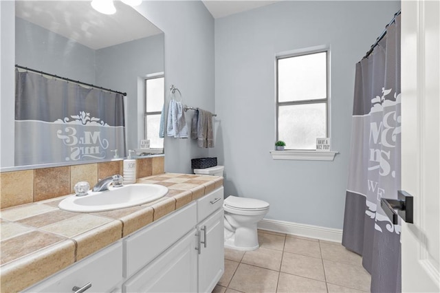 bathroom with tile patterned flooring, vanity, and toilet