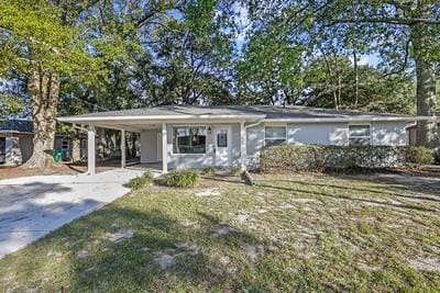 1492 W Hall Ave, Slidell, LA 70460 - ranch-style house with concrete driveway, a carport, and a front yard