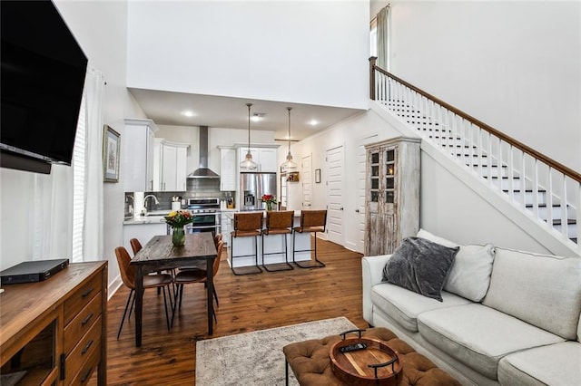 living room featuring dark hardwood / wood-style flooring and sink