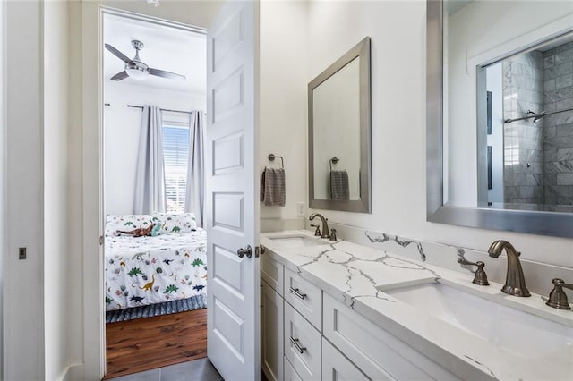 bathroom with tiled shower, ceiling fan, vanity, and hardwood / wood-style flooring