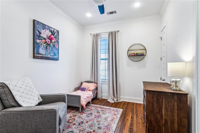 living area with dark hardwood / wood-style floors, ceiling fan, and crown molding