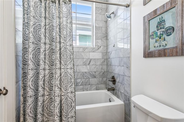 bathroom with shower / tub combo and toilet