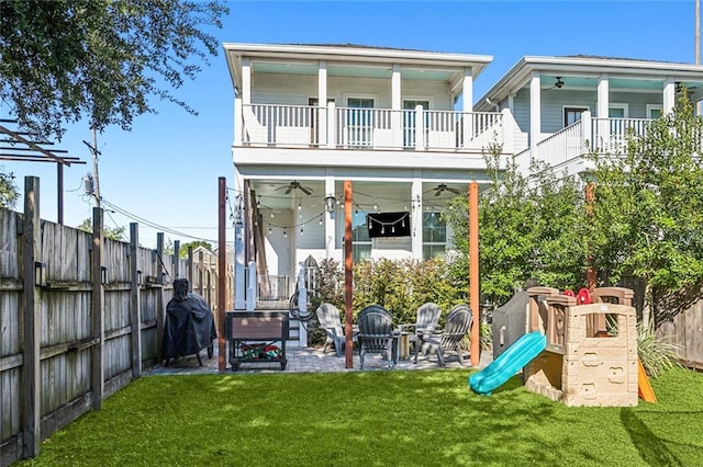 exterior space with a lawn, a patio area, ceiling fan, and a balcony