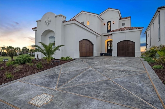 mediterranean / spanish-style home featuring a garage